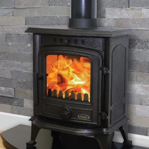 Coral 5kw Stove with large flames in the firebox, contrasting against a slate grey tiled wall
