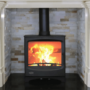 Atlantic Pearl 8kw Free Standing Stove in a tiled fireplace surrounded by a white mantelpiece
